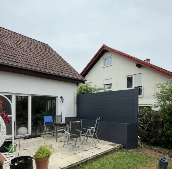 Terrasse mit neuer Sichtschutzwand aus Aluminium in Anthrazit und integriertem Hochbeet